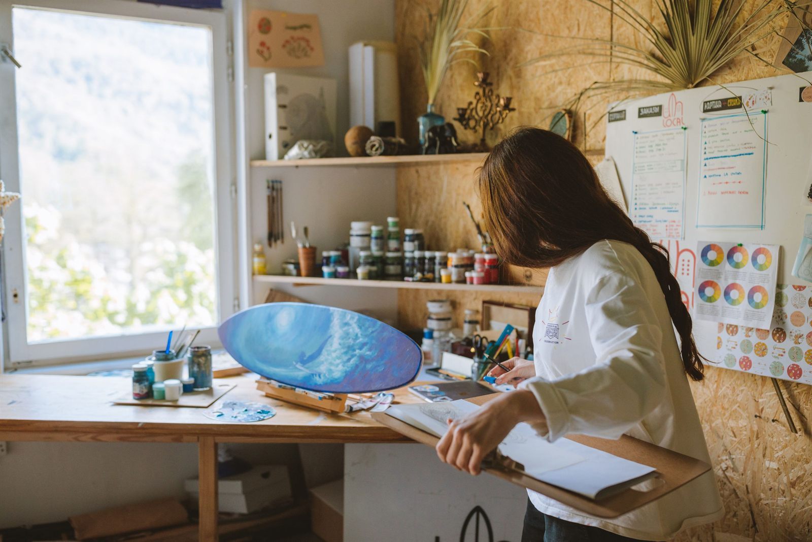 A painter at work in a sunlit studio